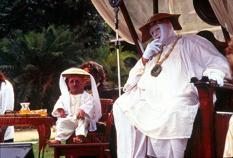 Marlon Brando and a friend sit on the set of The Island of Dr. Moreau