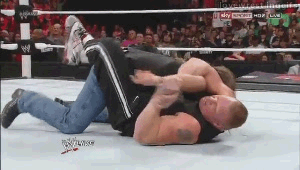 Brock Lesnar breaks Shawn Michaels' arm while HHH looks on