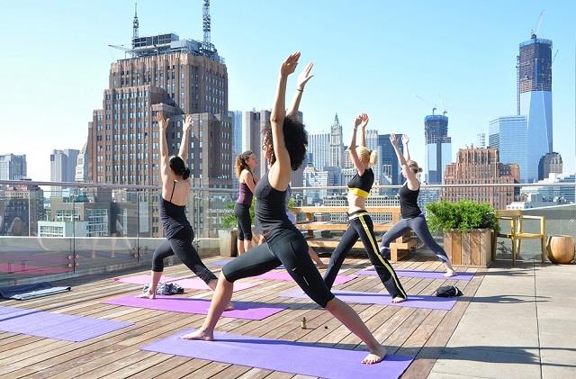 Women doing rooftop yoga